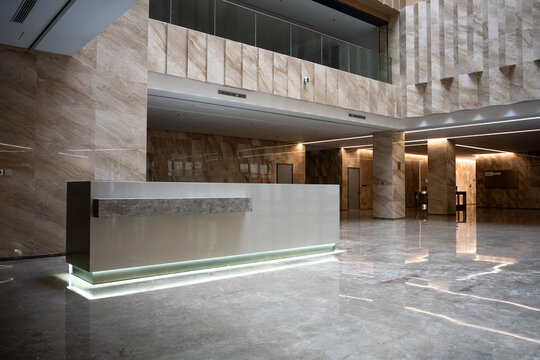 Modern marble office lobby with reception desk and spacious interior architecture