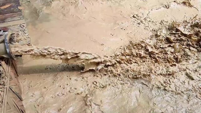 Mud Slurry Flow From Pipe Wet Soil Liquid Industrial Close Up