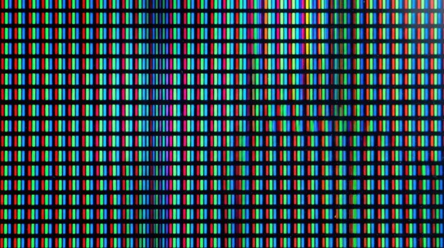 A high-resolution display shows a dense grid of colored pixels. The image displays a vibrant, multicolored pattern with a multitude of colors, including red, green, blue, cyan, magenta, and yellow.