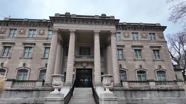 Grand stone building with columns and steps.