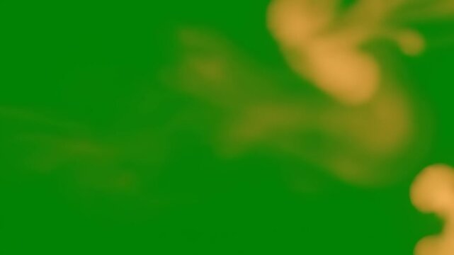Blurry Yellow Object on Green Background.