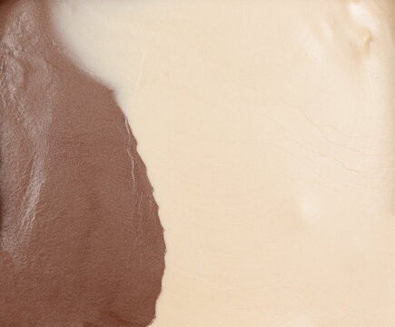 Dark and white cream chocolate spread surface, background and textur