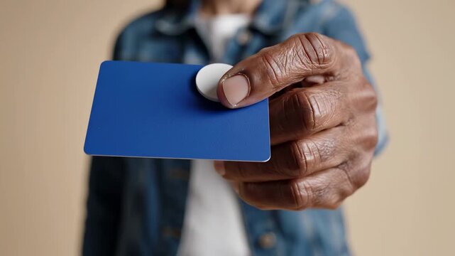 Secure Payment Concept showing a person holding a blank blue credit card for banking and shopping advertisements.