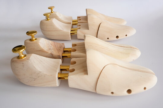 Professional wooden shoe trees for footwear on a white background