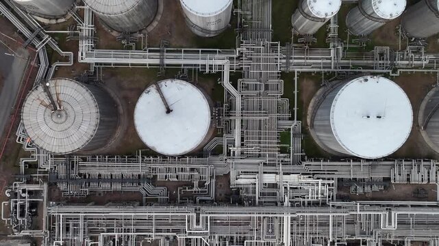 Aerial view white oil storage tank with pipeline steel, Crude oil industry, Storage fuel gas container tank petroleum refinery industrial factory, Oil storage chemical petrochemical refinery product.