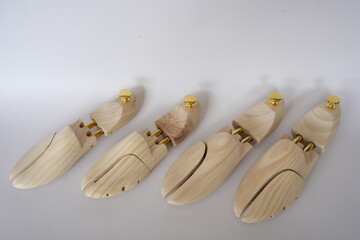 Fototapeta premium Professional wooden shoe trees for footwear on a white background