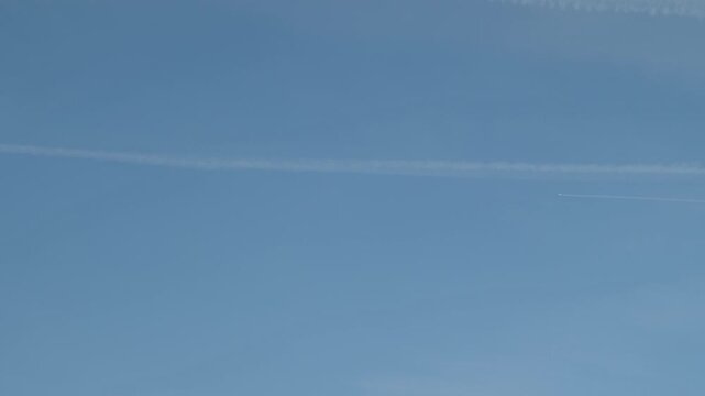 Jet streak in a distance across serene sky.