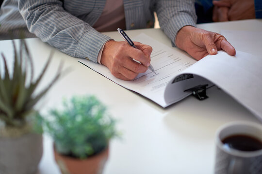 Senior, woman and hands with documents for signature, life insurance and form for asset management. Old person, legal paperwork and title deed in retirement for estate planning, will and testament.