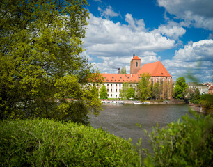 Fototapeta premium Wroclaw, Poland, 24th April 2026, view across the River Oder to the Roman Catholic parish church NMP on the Sand in Wroclaw