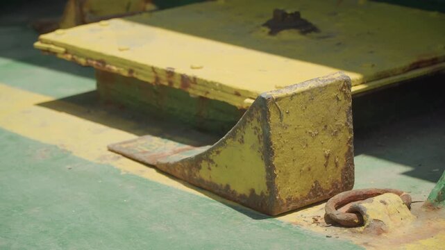 Close view of port equipment. Closeup shot of maritime hardware revealing corrosion and details. Detailed image showcasing ship mooring mechanisms and weathered metal components at dockside