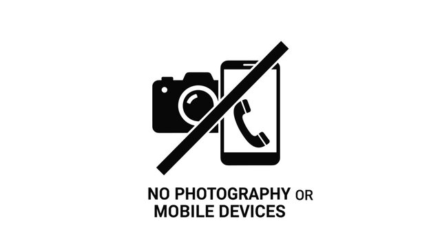 Black silhouette icon of a camera and a smartphone with a slash through them and text indicating no photography or mobile devices allowed.