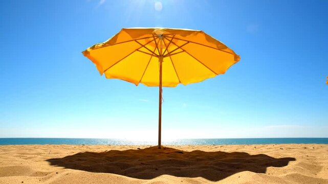 Bright yellow beach umbrella against a brilliant blue sky on a sunny summer day, seaside landscape