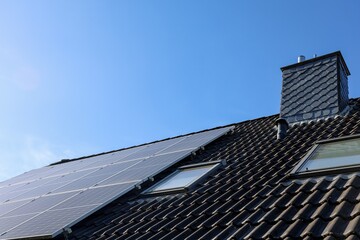 Fototapeta premium Solar panels generating clean energy on house roof