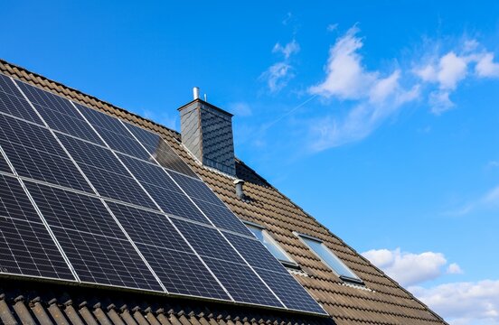 Solar panels generating clean energy on house roof