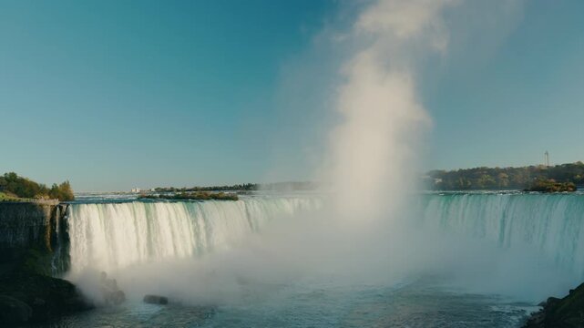 Horseshoe Falls at Niagara Falls with massive water cascade and rising mist cloud on border of Canada and USA