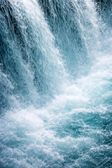 Obraz premium Cascading Water Majesty: A stunning high-angle shot captures the raw power and beauty of a cascading waterfall, with every drop of water creating a dynamic display of natural wonder.