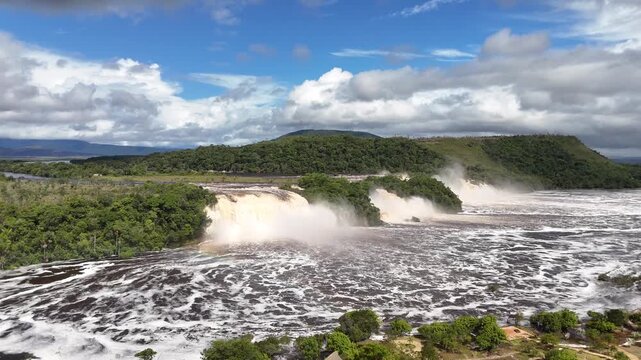Aerial drone shot of the Canaima Lagoon in Venezuela, showcasing the stunning tropical waters and distant tepui landscape, 4K