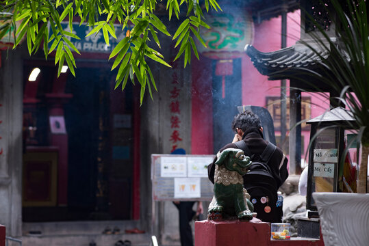 Visitor Praying with Incense Smoke at On Lang Pagoda in Cholon, Ho Chi Minh City, Vietnam