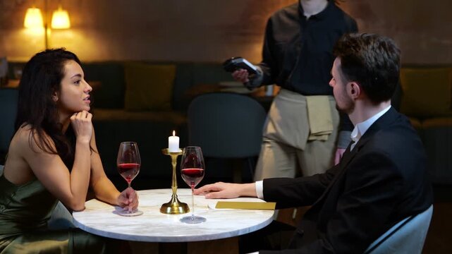 Young man tapping credit card on contactless card reader while paying in the restaurant. Lifestyle, love, relationships concept. Real time video.
