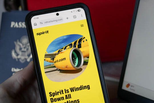 Spirit Airlines winding down operations: All flights canceled, passengers told not to go to airports. Smartphone in hand with message. (May 2, 2026). Editorial Use Only.