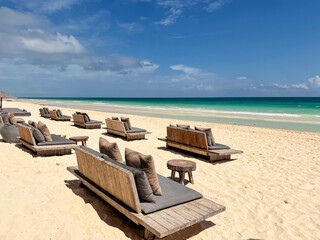 Fototapeta premium Many daybeds near sea at tropical resort