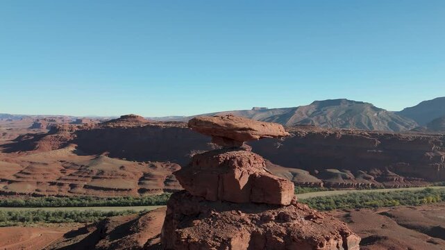Aerial video of Mexican Hat, a unique balanced rock formation near Mexican Hat, Utah, USA.