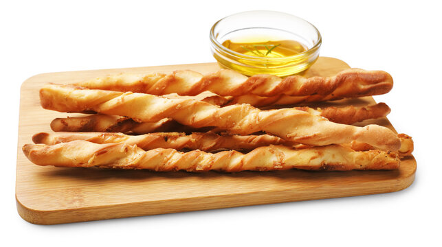 Delicious grissini sticks and oil with rosemary isolated on white