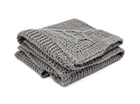 A stack of soft gray knit blankets on a clean white surface, great for photography props or home decor inspiration