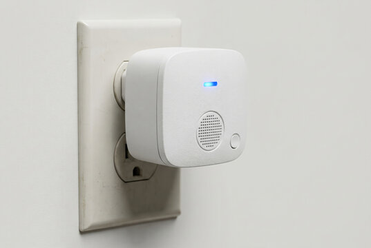 Ultrasonic pest repeller plugged into wall outlet, modern pest prevention device, rodent deterrent concept