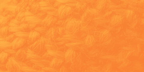 Obraz premium Vibrant orange knitted wool texture background with soft yarn weaving detail and cozy warmth for winter design concepts.