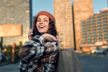 Fototapeta premium Woman shopping on city street, phone to ear and smile in golden hour glow, candid lifestyle portrait with authenticity, mindful living warmth and emotional storytelling in urban fashion scene.