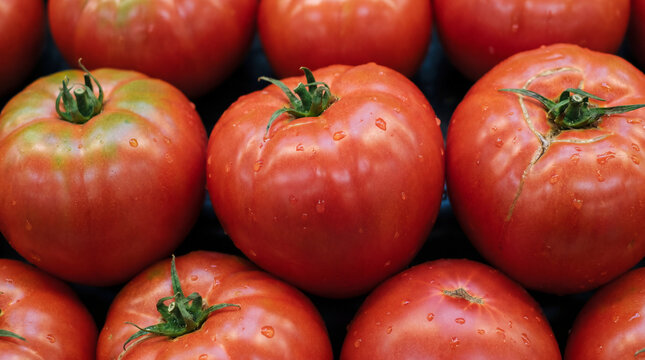 Ripe large tomatoes of the "Bull's heart" variety on the supermarket counter