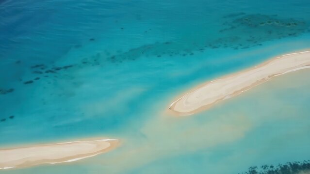 Aerial view of tropical sandbars surrounded by turquoise water, showcasing the gradual transition of colors and textures in a serene coastal landscape