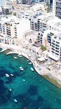 Beautiful Harbor With Boats in Malta on a Sunny Day Near Busy Waterfront Area