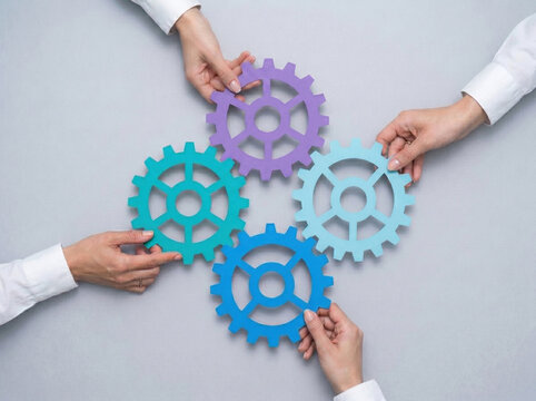 Business team connecting colorful gears for process synergy