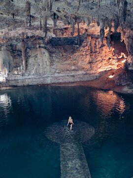 woman standing in the cenote cave pool in Mexico 
