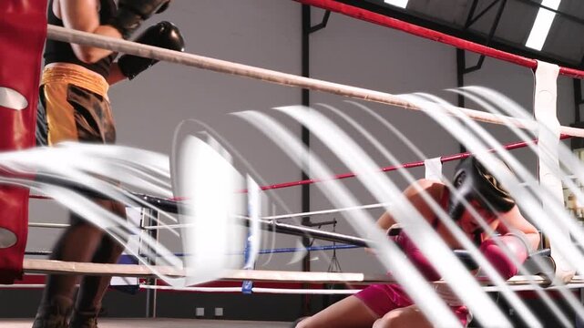 Left boxer charging and landing knockdown punch, pink boxer bracing ropes then rising and boxing
