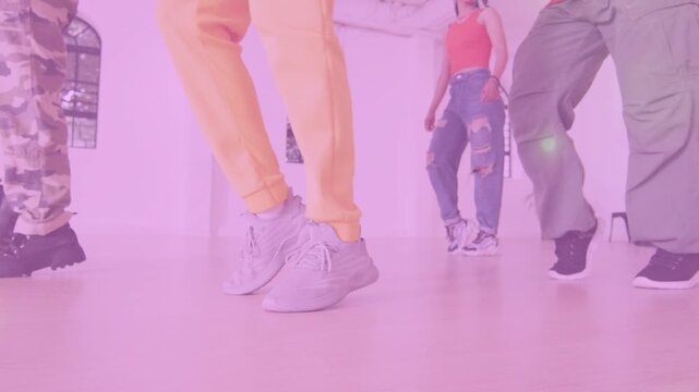 Lead dancer starting weight shift, dance quartet rehearsing steps in sync, pink flare showing feet