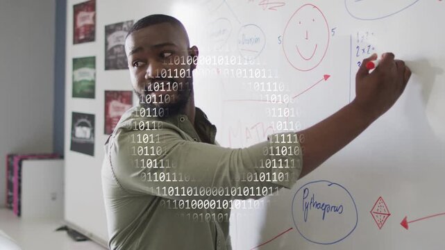 Male teacher starting writing red marker at board teaching math with binary overlay crossing board