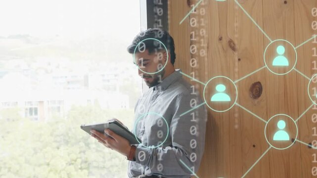 Dev leaning by window tapping tablet and visualizing network data as binary overlays covering scene