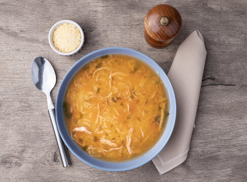 Chicken soup in over wooden table