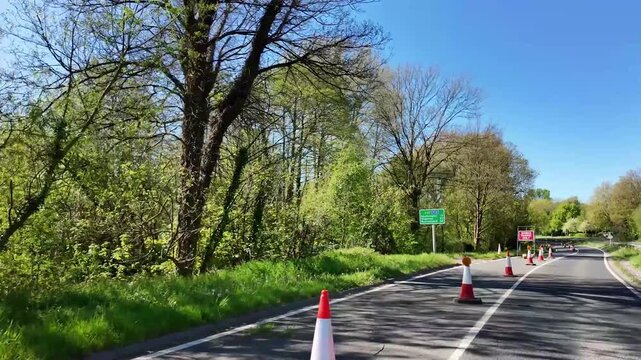 Winchester Hampshire England UK. 24.04.2026. Video. Red and white traffic cones on the inner lane of the A33 highway restricting vehicles to the outer lane approaching major roadworks.