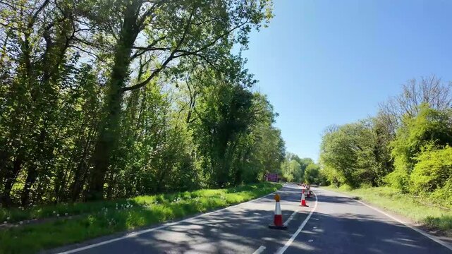Winchester Hampshire England UK. 24.04.2026. Video. Red and white traffic cones on the inner lane of the A33 highway restricting vehicles to the outer lane approaching major roadworks.
