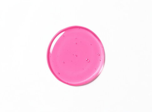 A pink frisbee resting on a clean white surface, ready for play or toss