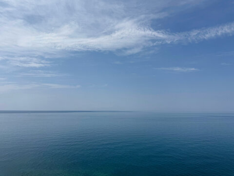 Open sea with calm blue water and sunny sky.