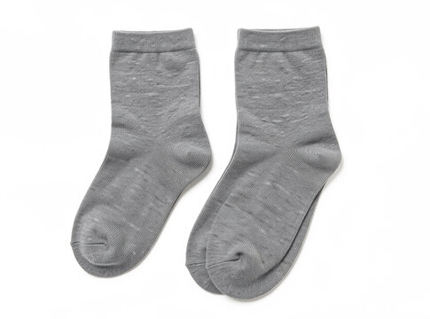 A pair of gray socks placed on a white surface