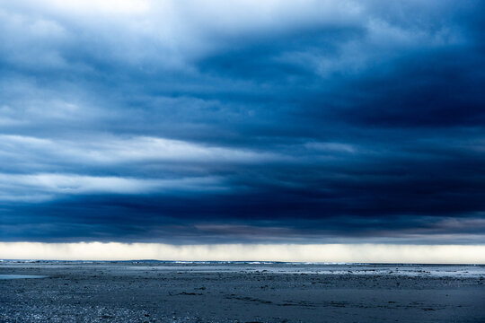 stormy clouds hover over lagoon and san beach, Hermanus, South Africa