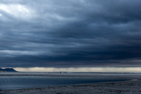 stormy clouds hover over lagoon and san beach, Hermanus, South Africa