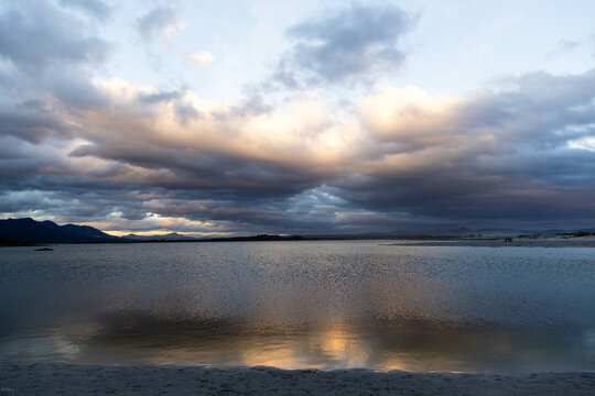 stormy clouds hover over lagoon and san beach, Hermanus, South Africa