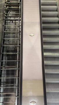 Escalator and stairs at a public space in Prague Florence station during daylight
